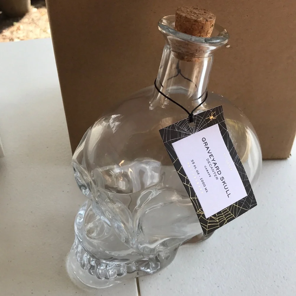 Pottery Barn graveyard skull decanter BN